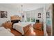 Bedroom featuring hardwood floors, a double window, and wall decorations at 245 River Laurel Way, Woodstock, GA 30188