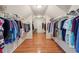 Spacious walk-in closet with ample hanging space and hardwood floors at 245 River Laurel Way, Woodstock, GA 30188