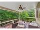 Spacious covered deck featuring comfortable seating, ceiling fan, and scenic wooded views perfect for outdoor relaxation at 245 River Laurel Way, Woodstock, GA 30188