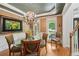 Inviting dining room featuring a chandelier, and natural light with access to the porch and views of the stairwell at 245 River Laurel Way, Woodstock, GA 30188