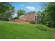 Two story traditional brick home with lush green lawn and landscaping at 245 River Laurel Way, Woodstock, GA 30188
