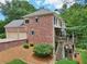 Brick home with a two-car garage, elevated deck, and lush landscaping at 245 River Laurel Way, Woodstock, GA 30188