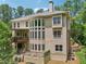 Back of home with large windows, an elevated deck, and beautiful backyard at 245 River Laurel Way, Woodstock, GA 30188