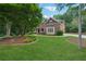 Lovely brick home featuring well-maintained landscaping, a curved walkway, and a serene setting at 245 River Laurel Way, Woodstock, GA 30188