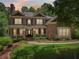 Charming brick home with a covered front porch, lush landscaping, and ample natural light from large windows at 245 River Laurel Way, Woodstock, GA 30188