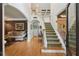 Inviting foyer features a beautiful staircase, hardwood floors, and an open layout, seamlessly connecting living spaces at 245 River Laurel Way, Woodstock, GA 30188