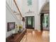 Elegant foyer boasts high ceilings, a decorative transom window, and hardwood floors with views into the sunny yard at 245 River Laurel Way, Woodstock, GA 30188