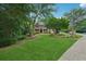 Beautiful brick home with a sprawling lawn and mature trees in a peaceful residential neighborhood at 245 River Laurel Way, Woodstock, GA 30188