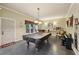 Spacious game room featuring a pool table, wet bar, and piano at 245 River Laurel Way, Woodstock, GA 30188