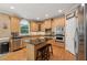 Kitchen with island, stainless appliances, and custom wood cabinetry at 245 River Laurel Way, Woodstock, GA 30188