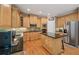 Well-equipped kitchen with stainless steel appliances, custom cabinetry, and a granite island at 245 River Laurel Way, Woodstock, GA 30188