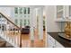 This living room boasts a fireplace, large windows, hardwood floors and decorative trim, with kitchen views at 245 River Laurel Way, Woodstock, GA 30188