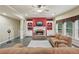 Inviting living room with a brick fireplace, built-in bookshelves, and large windows at 245 River Laurel Way, Woodstock, GA 30188