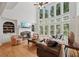 Sun-filled living room boasts a fireplace, built-ins and large windows with backyard views at 245 River Laurel Way, Woodstock, GA 30188