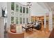 Spacious living room with a fireplace, large windows, and an open floor plan at 245 River Laurel Way, Woodstock, GA 30188