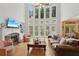 Bright living room with hardwood floors, fireplace, and expansive windows offering lovely views at 245 River Laurel Way, Woodstock, GA 30188