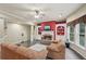 Inviting living room with a brick fireplace, built-in bookshelves, and large windows at 245 River Laurel Way, Woodstock, GA 30188