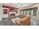 Inviting living room with a brick fireplace, built-in bookshelves, and large windows at 245 River Laurel Way, Woodstock, GA 30188