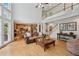 Open-concept living room featuring a fireplace, hardwood floors, and staircase access to a loft space at 245 River Laurel Way, Woodstock, GA 30188