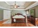 Well lit main bedroom featuring hardwood floors, a ceiling fan, a large closet, and outdoor views at 245 River Laurel Way, Woodstock, GA 30188
