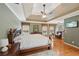 Spacious primary bedroom with hardwood floors, ceiling fan, and views of the outdoors at 245 River Laurel Way, Woodstock, GA 30188