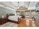 Expansive bedroom featuring a ceiling fan, light green walls, hardwood floors and outdoor views at 245 River Laurel Way, Woodstock, GA 30188