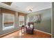 Bright sitting area featuring hardwood floors, windows and natural light and a comfortable chair at 245 River Laurel Way, Woodstock, GA 30188