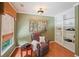 Cozy room featuring a comfortable chair, bookshelf, hardwood floors, and bright natural light at 245 River Laurel Way, Woodstock, GA 30188