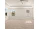 Carpeted bedroom with tray ceiling and windows provides natural light at 2939 Champions Way, Loganville, GA 30052