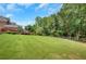 Expansive backyard with lush green lawn and mature trees at 4075 Hickory Fairway Dr, Woodstock, GA 30188