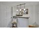 A charming bar area with pendant lighting, decorative details, and a view to the rest of the room at 4075 Hickory Fairway Dr, Woodstock, GA 30188