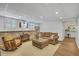 Spacious finished basement with brick feature wall, cozy seating, and wood-look flooring at 4075 Hickory Fairway Dr, Woodstock, GA 30188