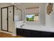 Bathroom with a separate tub and shower, a window with privacy blind, and a flower decoration at 4075 Hickory Fairway Dr, Woodstock, GA 30188