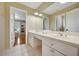 Bright bathroom featuring double sinks, vanity, and views into other rooms at 4075 Hickory Fairway Dr, Woodstock, GA 30188