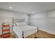 Cozy bedroom with light-colored walls, wood floors, and natural light from a window at 4075 Hickory Fairway Dr, Woodstock, GA 30188