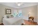 Comfortable bedroom with hardwood floors, ceiling fan, and cozy furnishings at 4075 Hickory Fairway Dr, Woodstock, GA 30188