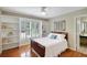 Bedroom with hardwood floors, large windows, and built-in shelving units at 4075 Hickory Fairway Dr, Woodstock, GA 30188
