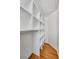 Walk-in closet includes built-in shelving and wood flooring at 4075 Hickory Fairway Dr, Woodstock, GA 30188