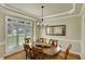 Inviting dining room with ample natural light, a large wood table, and decorative mirror at 4075 Hickory Fairway Dr, Woodstock, GA 30188
