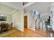 Inviting foyer with hardwood floors, staircase with dark trim, and views into the dining and living areas at 4075 Hickory Fairway Dr, Woodstock, GA 30188