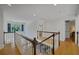 Hallway with staircase featuring wooden floors and white railings at 4075 Hickory Fairway Dr, Woodstock, GA 30188