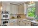 Well-equipped kitchen with stainless steel oven, granite countertops, and natural light at 4075 Hickory Fairway Dr, Woodstock, GA 30188