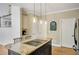Stylish kitchen island with granite countertop, cooktop, and pendant lighting at 4075 Hickory Fairway Dr, Woodstock, GA 30188