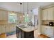 Bright kitchen featuring an island cooktop, granite countertops and views into the breakfast nook at 4075 Hickory Fairway Dr, Woodstock, GA 30188