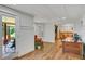 Living room with wood floors, a sliding glass door to a porch, and decorative wainscoting at 4075 Hickory Fairway Dr, Woodstock, GA 30188