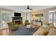 Cozy living room with fireplace, shuttered windows, ceiling fan and comfortable seating arrangement at 4075 Hickory Fairway Dr, Woodstock, GA 30188