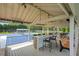 View of tennis courts from pavilion, with a counter bar, benches and ceiling fans at 4075 Hickory Fairway Dr, Woodstock, GA 30188