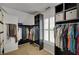 Organized walk-in closet with ample hanging space and shelving for clothing and accessories at 4075 Hickory Fairway Dr, Woodstock, GA 30188
