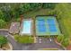 Aerial view of community pool and tennis courts surrounded by mature trees and manicured landscaping at 10731 Bossier Dr, Alpharetta, GA 30022