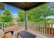 Outdoor balcony with seating and a great view of the surrounding trees at 10731 Bossier Dr, Alpharetta, GA 30022